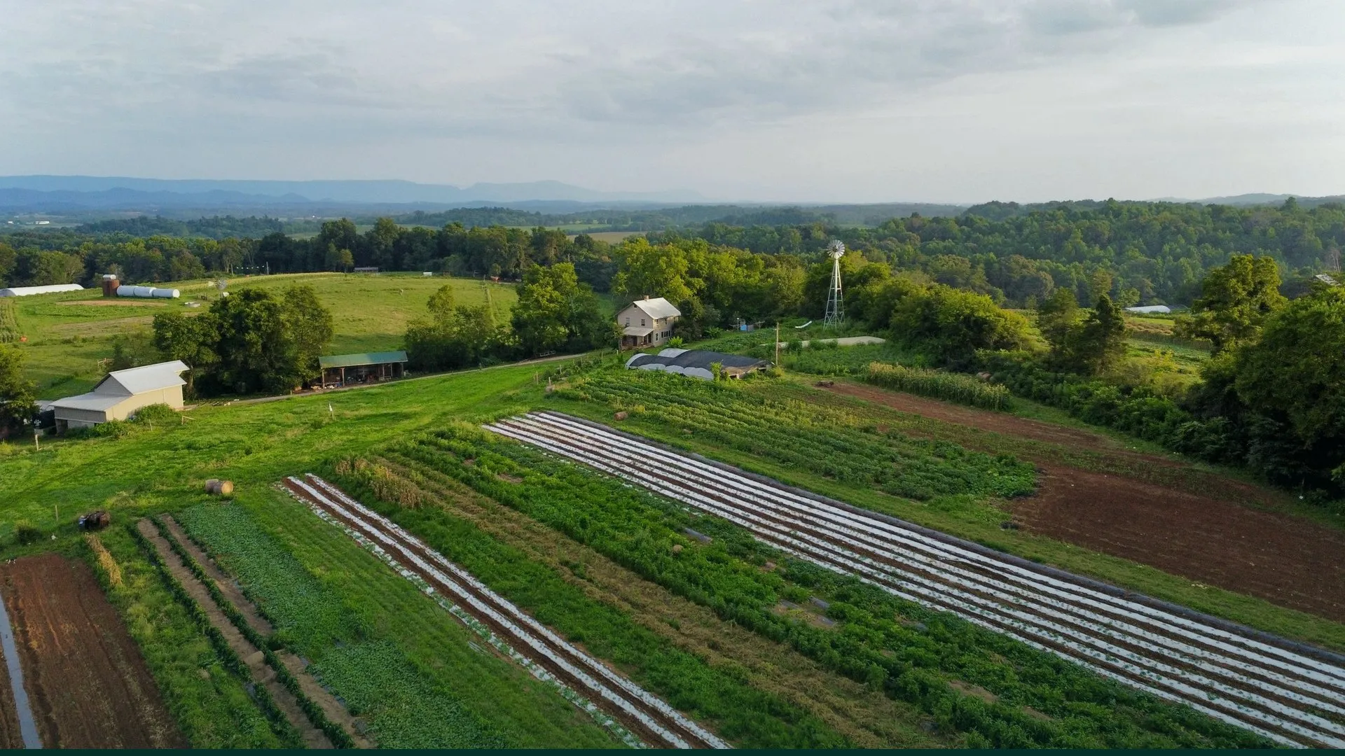 Aerial view of a rural farm with distant mountains